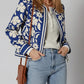 Blue and white floral bomber jacket with striped trim and buttoned cuffs