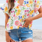 Floral boxy fit ruffled short sleeve blouse with vibrant blossoms