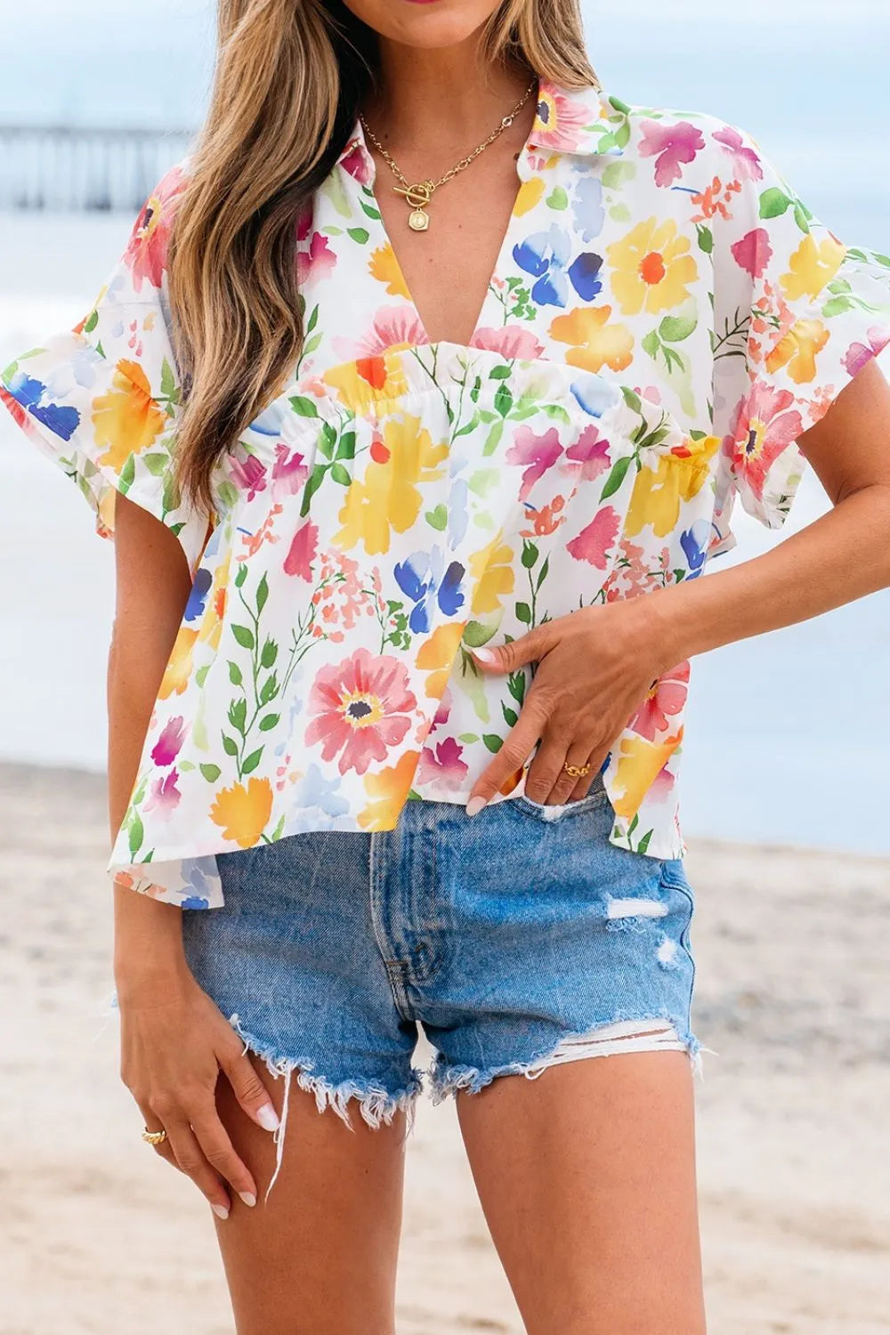 Floral boxy fit ruffled short sleeve blouse with vibrant blossoms