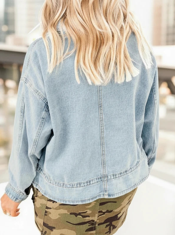 Light-wash oversized denim jacket with frayed hem and button-up design