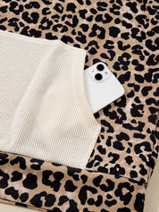 White iPhone 13 on leopard print hoodie fabric
