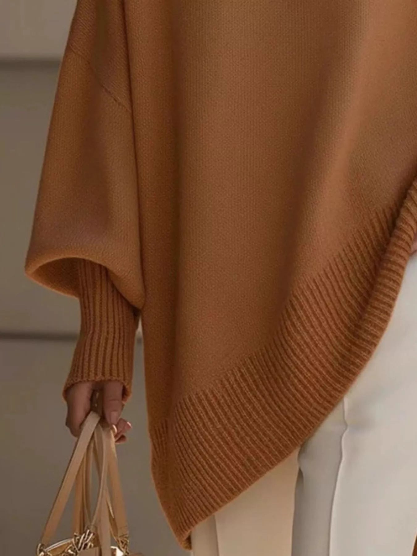 Women’s camel-colored oversized batwing sleeve knit poncho with ribbed cuffs