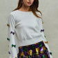 White SO ME Mardi Gras sweater with colorful sequined bows
