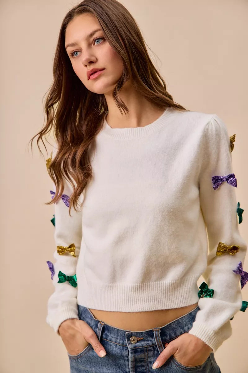 White SO ME Mardi Gras knit sweater with colorful sequined bows