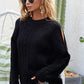 Black cable-knit BiBi Twist sweater with open cut-out shoulders