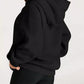 Black oversized kangaroo pocket long sleeve hoodie with relaxed fit and ribbed cuffs