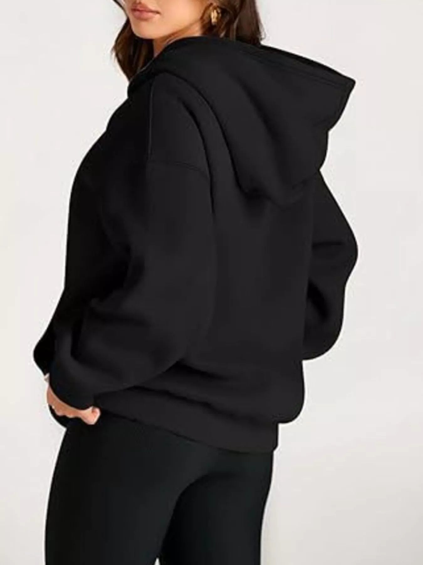 Black oversized kangaroo pocket long sleeve hoodie with relaxed fit and ribbed cuffs