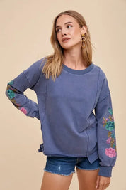 Blue floral embroidered Annie Wear sweatshirt with side ties and denim shorts