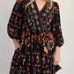 Bohemian black floral print long sleeve mini dress with puff sleeves and V-neckline