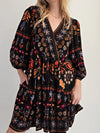 Bohemian black floral print long sleeve mini dress with puff sleeves and V-neckline