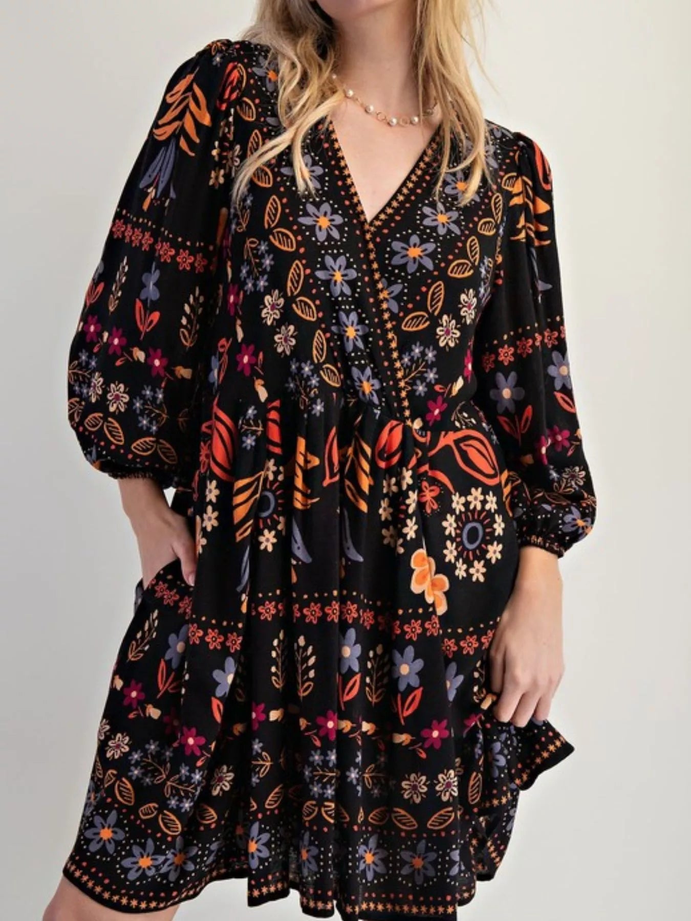 Bohemian black floral print long sleeve mini dress with puff sleeves and V-neckline