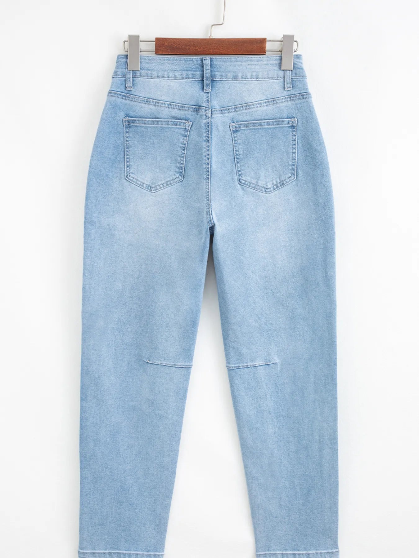 High-rise barrel relaxed light blue distressed denim jeans with patch pockets