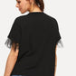Black round neck short sleeve top with sheer tulle ruffle cuffs