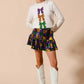 White long-sleeved sweater with Mardi Gras purple, gold, green sequined bows