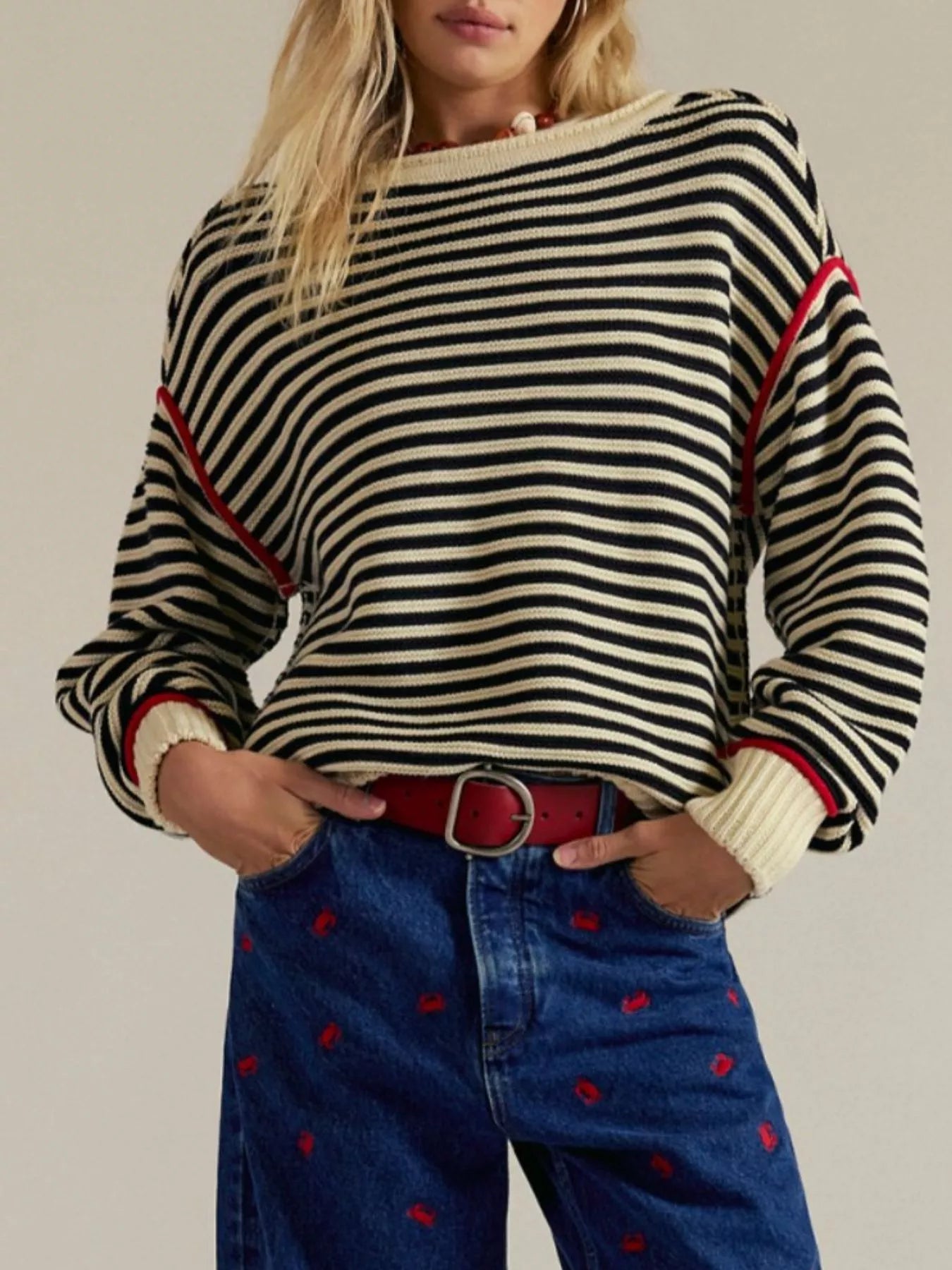 Striped round neck long sleeve sweater in black and white with red trim