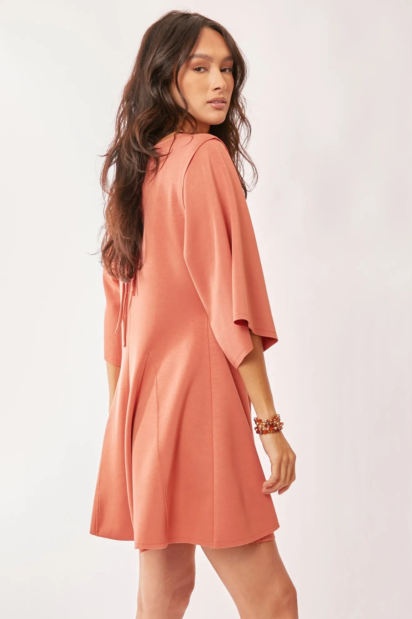 Davi & Dani soft peach draped sleeve ties back skort romper