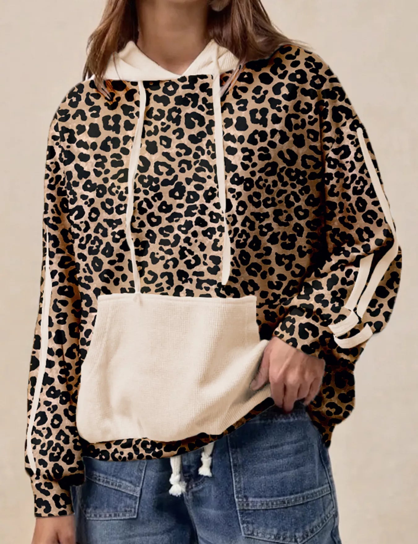 Leopard print long sleeve hoodie with white accents, drawstring hood, and pocket