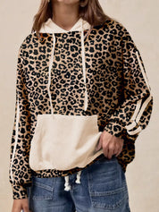 Leopard print long sleeve hoodie with white accents, drawstring hood, and pocket