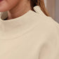 Cream-colored soft-textured mock neck dropped shoulder sweatshirt