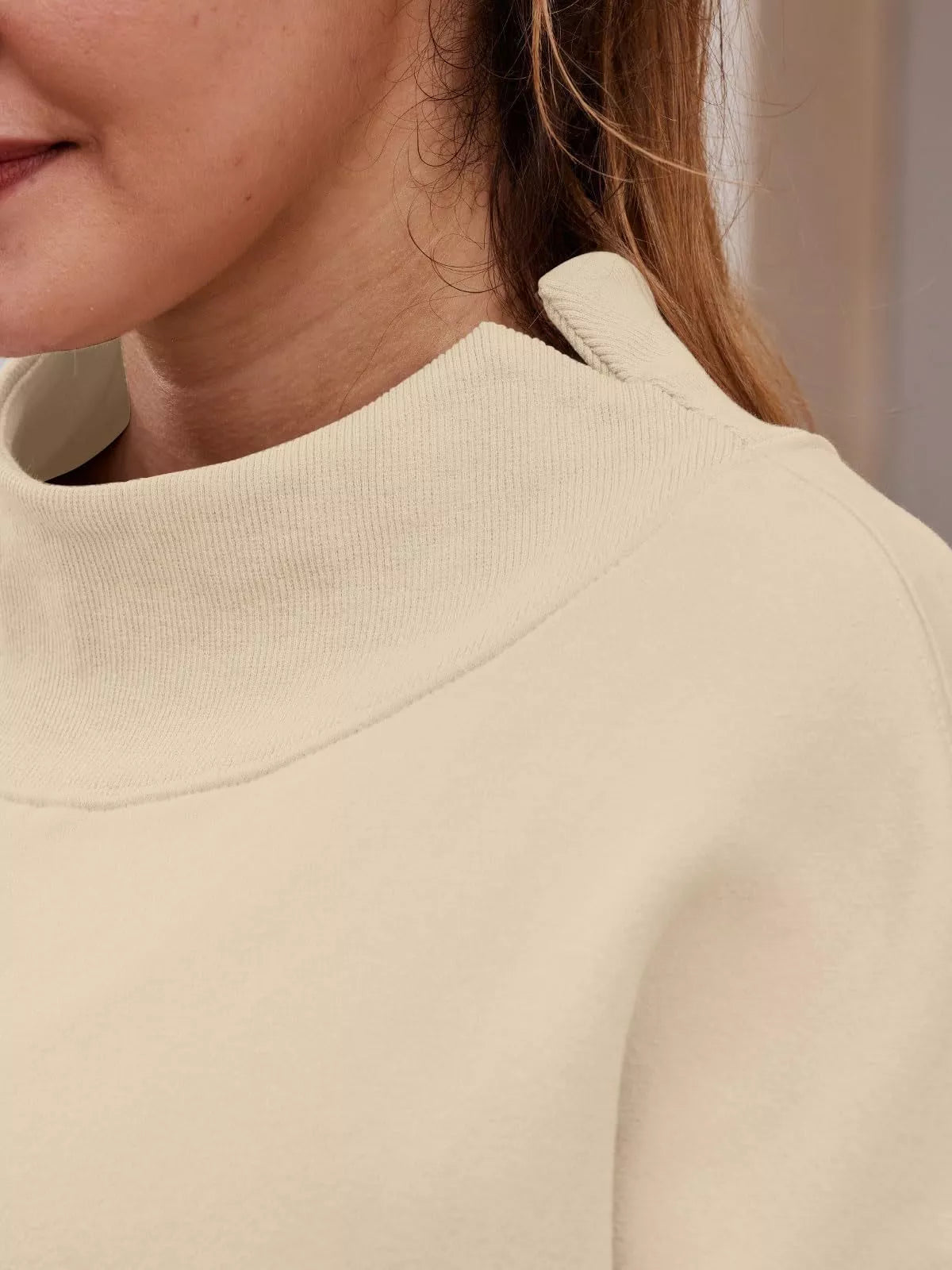 Cream-colored soft-textured mock neck dropped shoulder sweatshirt