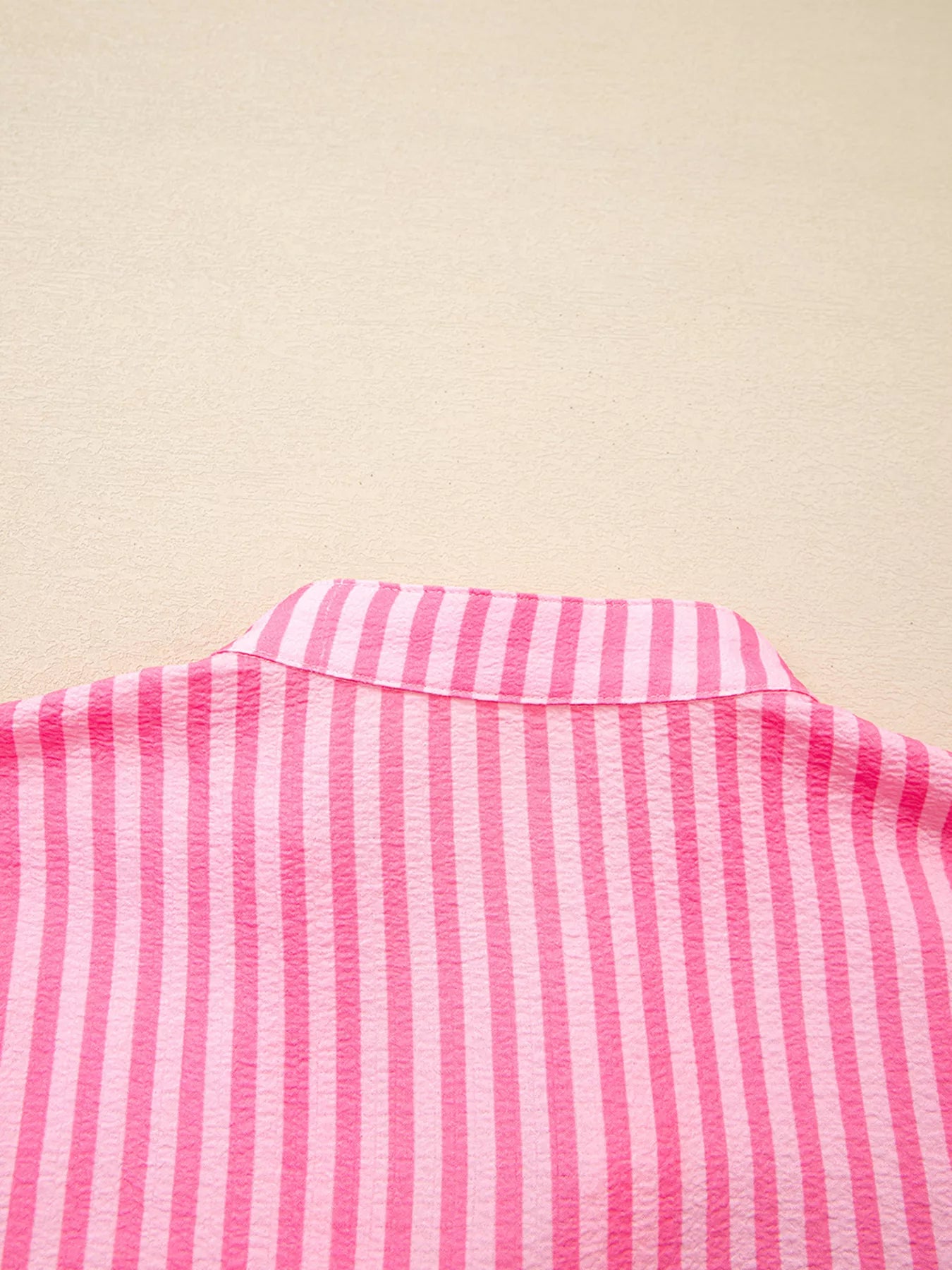 Pink and white striped button-up shirt with crisp collar on flowy mini dress