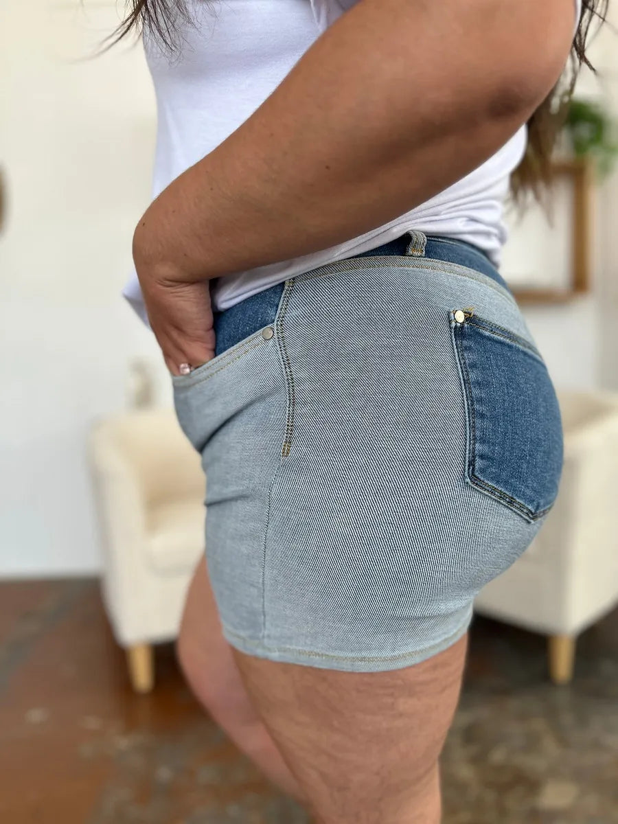 Back view of Judy Blue full size color block denim shorts with light-wash denim, dark blue pocket and silver hardware