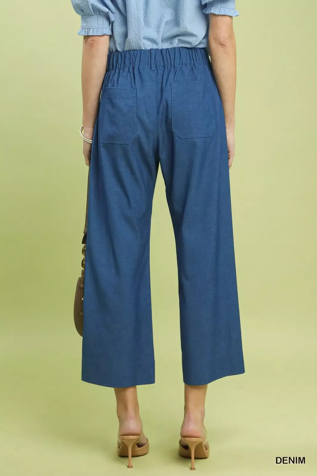 Back view of Umgee denim wide leg crop pants with high-waisted elastic waistband and back pockets