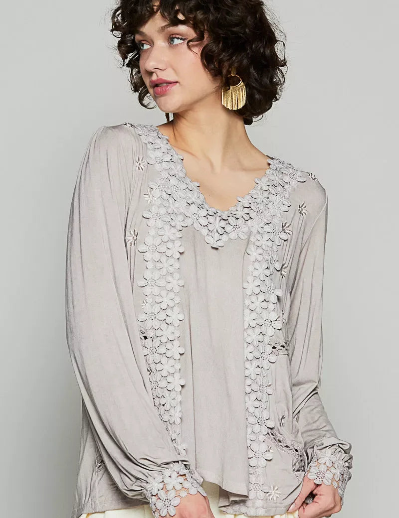 Beige POL floral embroidery blouse with sheer sleeves and gold earrings