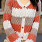 Cozy color block button-up cardigan in rust orange, cream, and gray stripes
