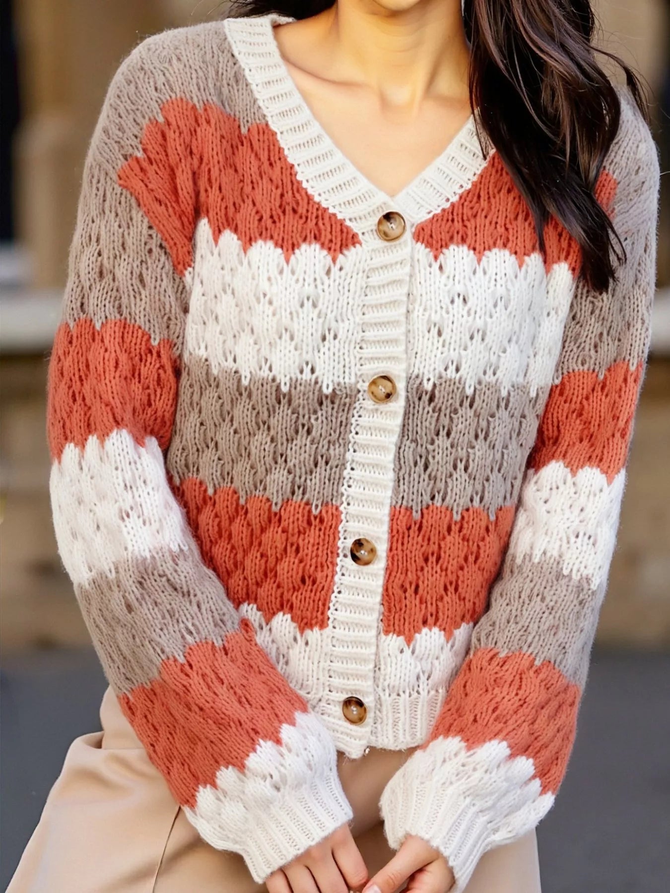 Cozy color block button-up cardigan in rust orange, cream, and gray stripes