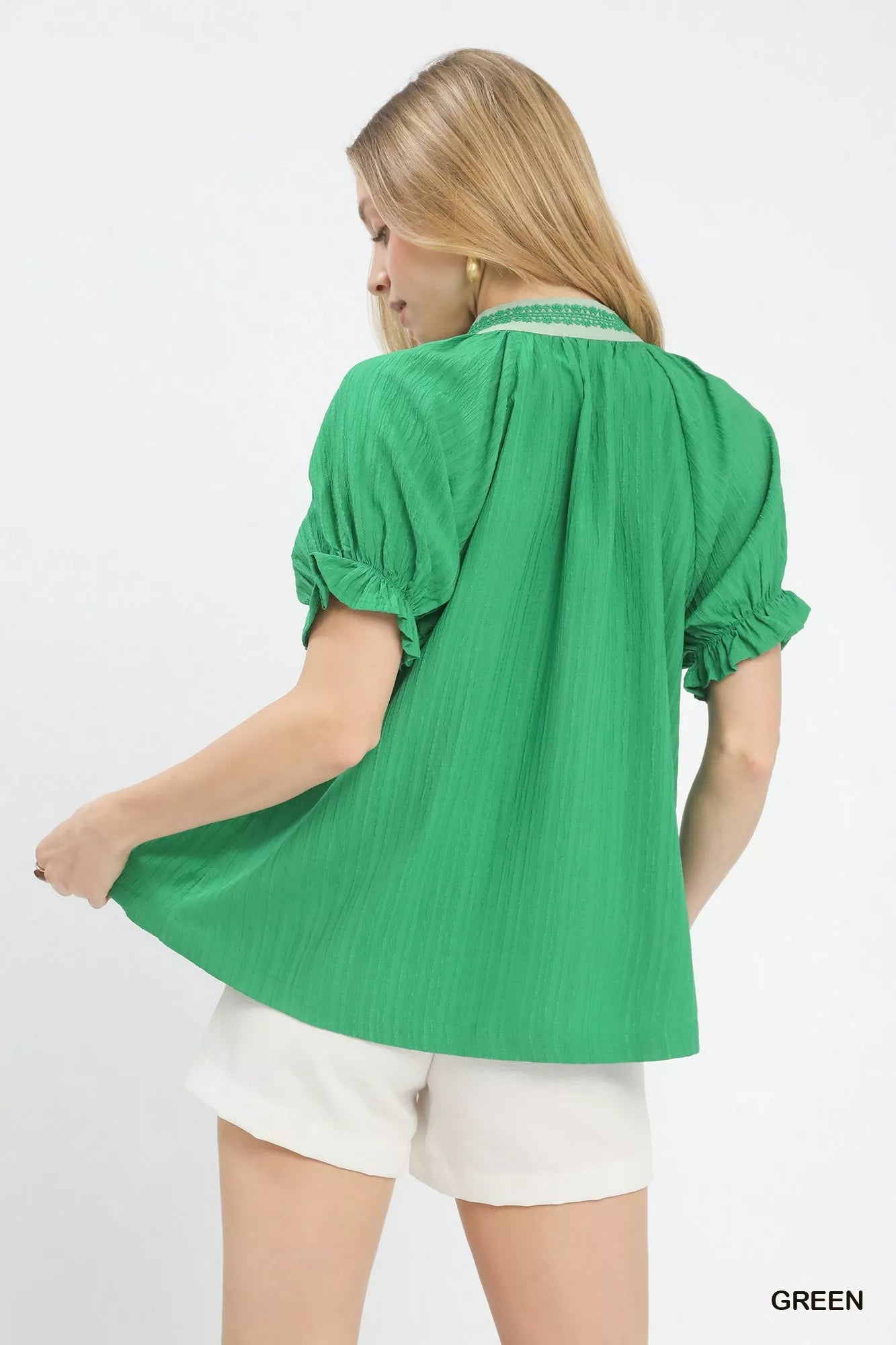 Vibrant green Umgee textured V-neck top with puffed sleeves and ruffled hem