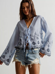 Blue floral embroidered tie-front blouse with bell sleeves