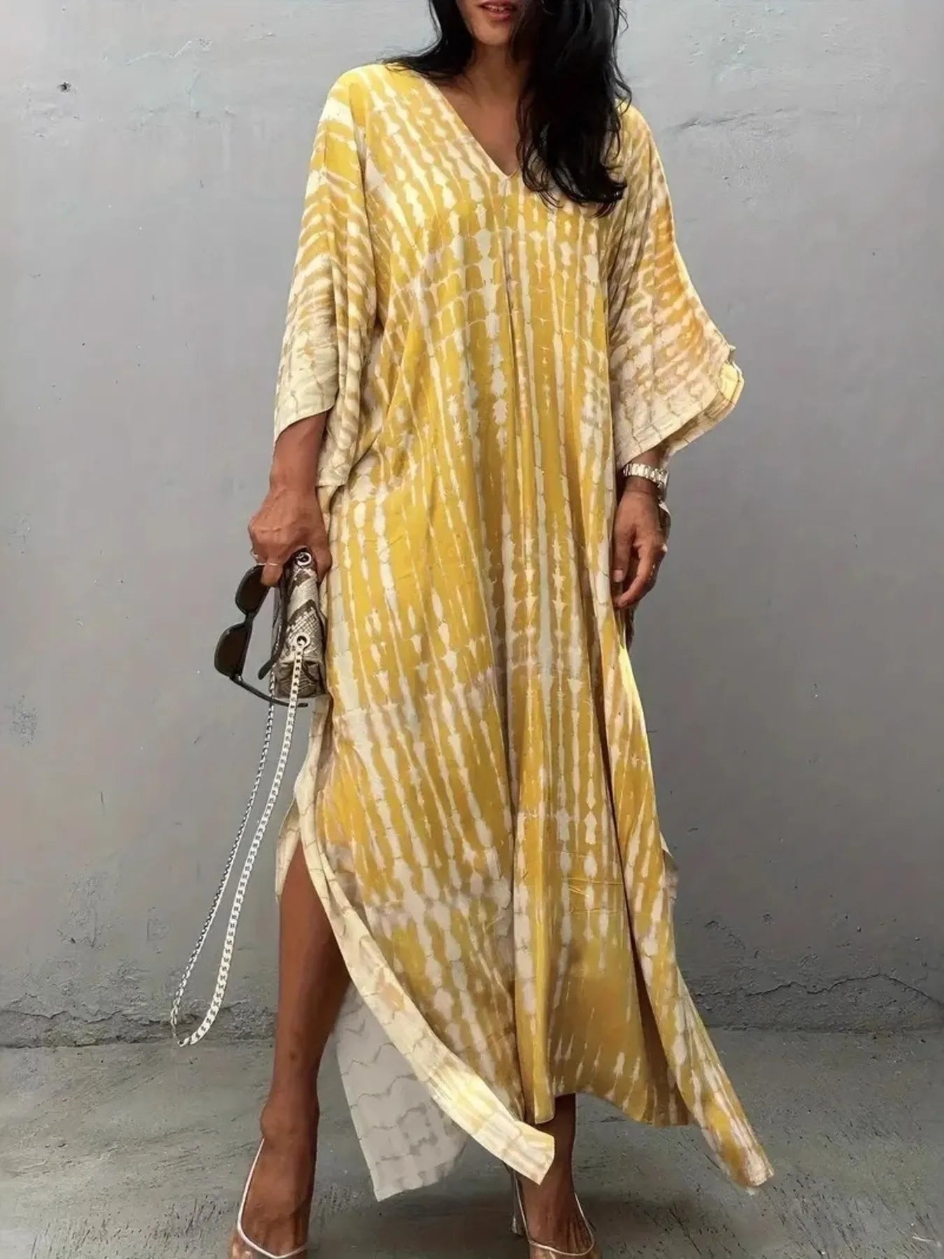 Flowing yellow and cream tie-dye V-neck maxi dress with wide sleeves and high slit