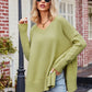 Olive green oversized V-neck knit sweater with ribbed cuffs and hem