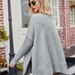 Light gray V-neck slit poncho sweater with ribbed cuffs and hem