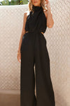 Black sleeveless high-neck jumpsuit with cinched waist and cutout sides
