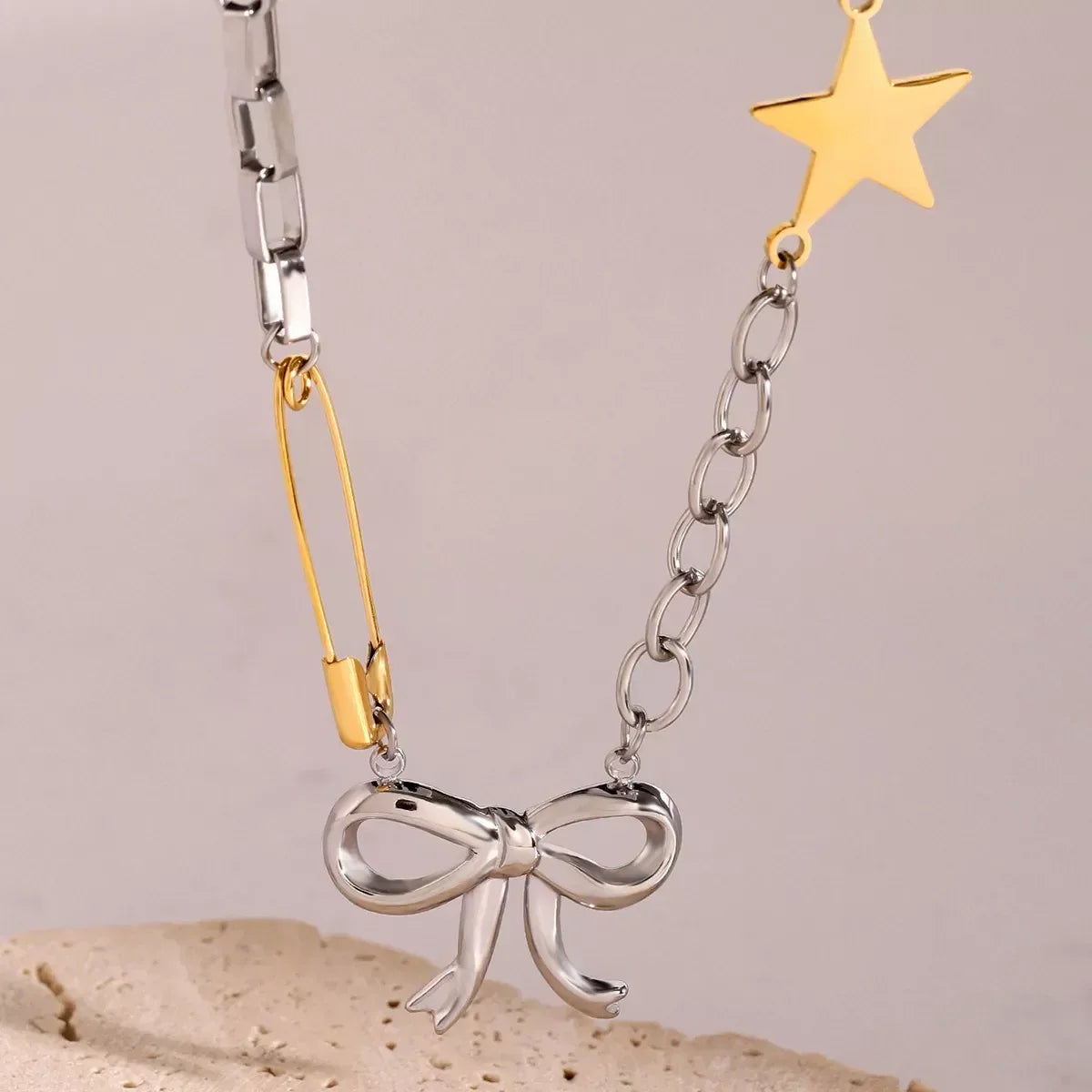 Two-Tone Stainless Steel Bow Star Necklace - DAVERRI FASHIONS