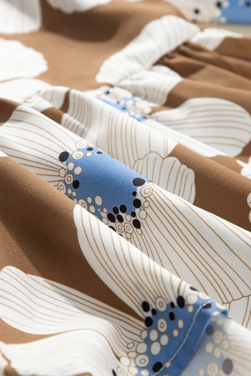 Floral print striped tie sleeve blouse in warm brown with white flowers and blue motifs