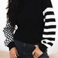 Black and white striped knit turtleneck sweater with checkered sleeve