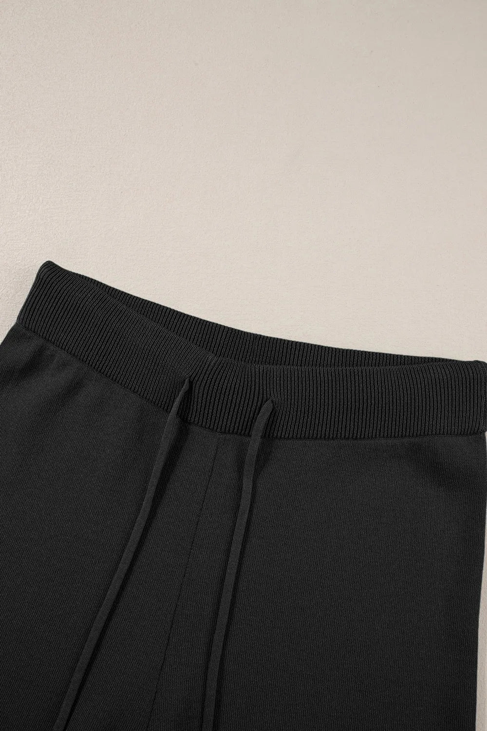 Black drawstring pants with ribbed elastic texture in set