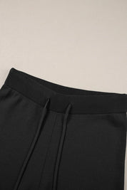 Black drawstring pants with ribbed elastic texture in set