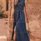 Button front sleeveless blue denim dress with tiered skirt and tied waistband
