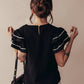 Black contrast trim blouse with white ruffled sleeves and back zipper