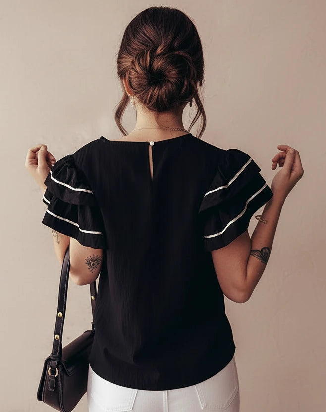 Black contrast trim blouse with white ruffled sleeves and back zipper