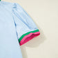 Notched puff sleeve swing dress in light blue with pink and green striped cuffs