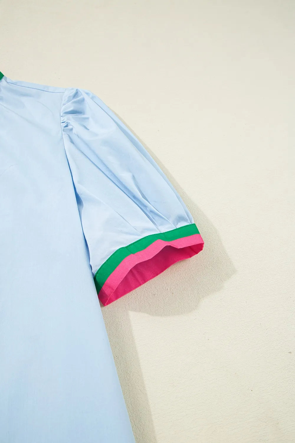 Notched puff sleeve swing dress in light blue with pink and green striped cuffs