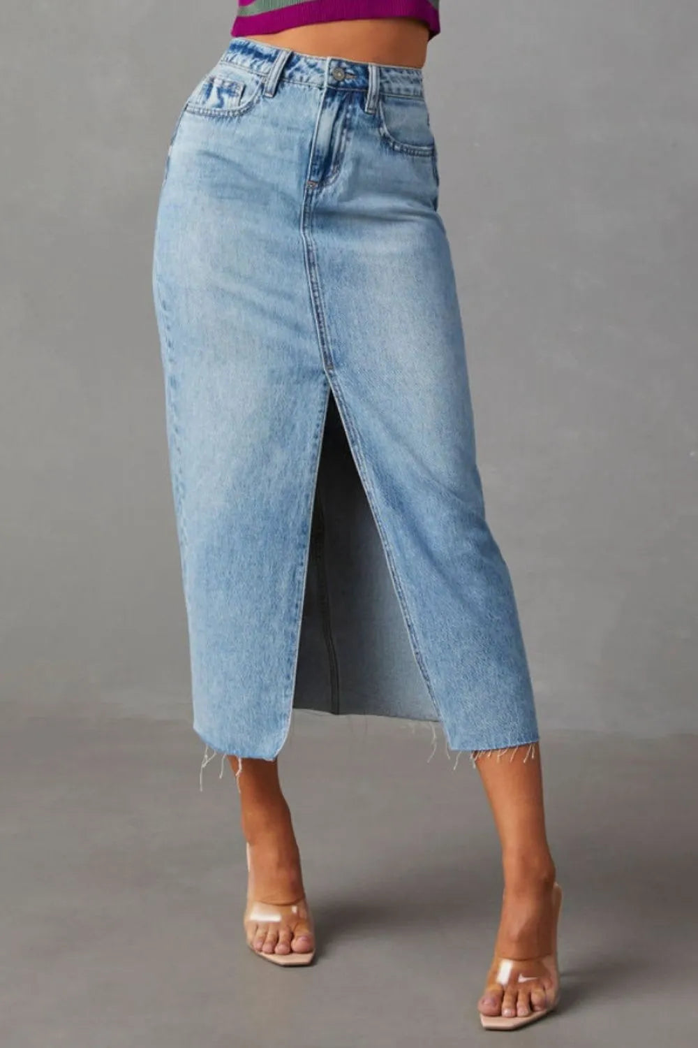 Light-wash denim midi skirt with front slit and frayed hem