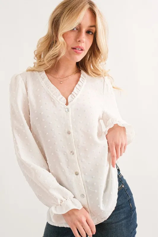 White ruffled button-down blouse with floral embroidery and polka dots