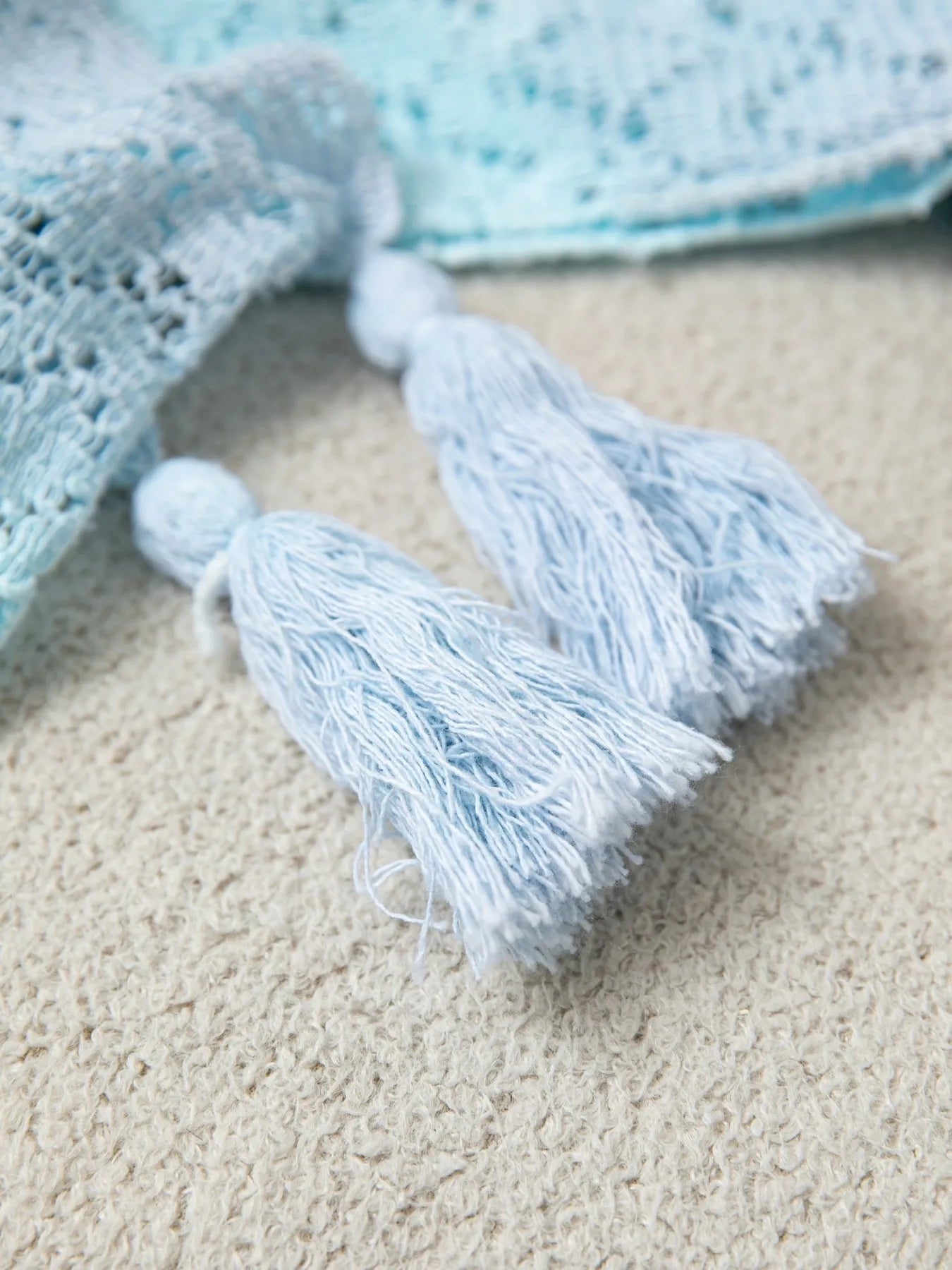 Light blue Daverri openwork tassel gradient knit cover up with frayed textured ends