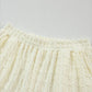 Cream-colored textured cotton skirt from Daverri set with elastic waistband